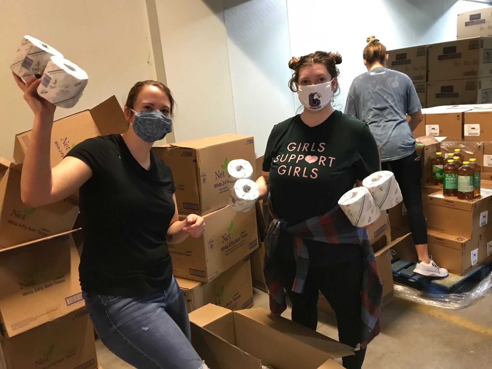 Volunteers sorting hygiene and cleaning supplies for delivery.jpg